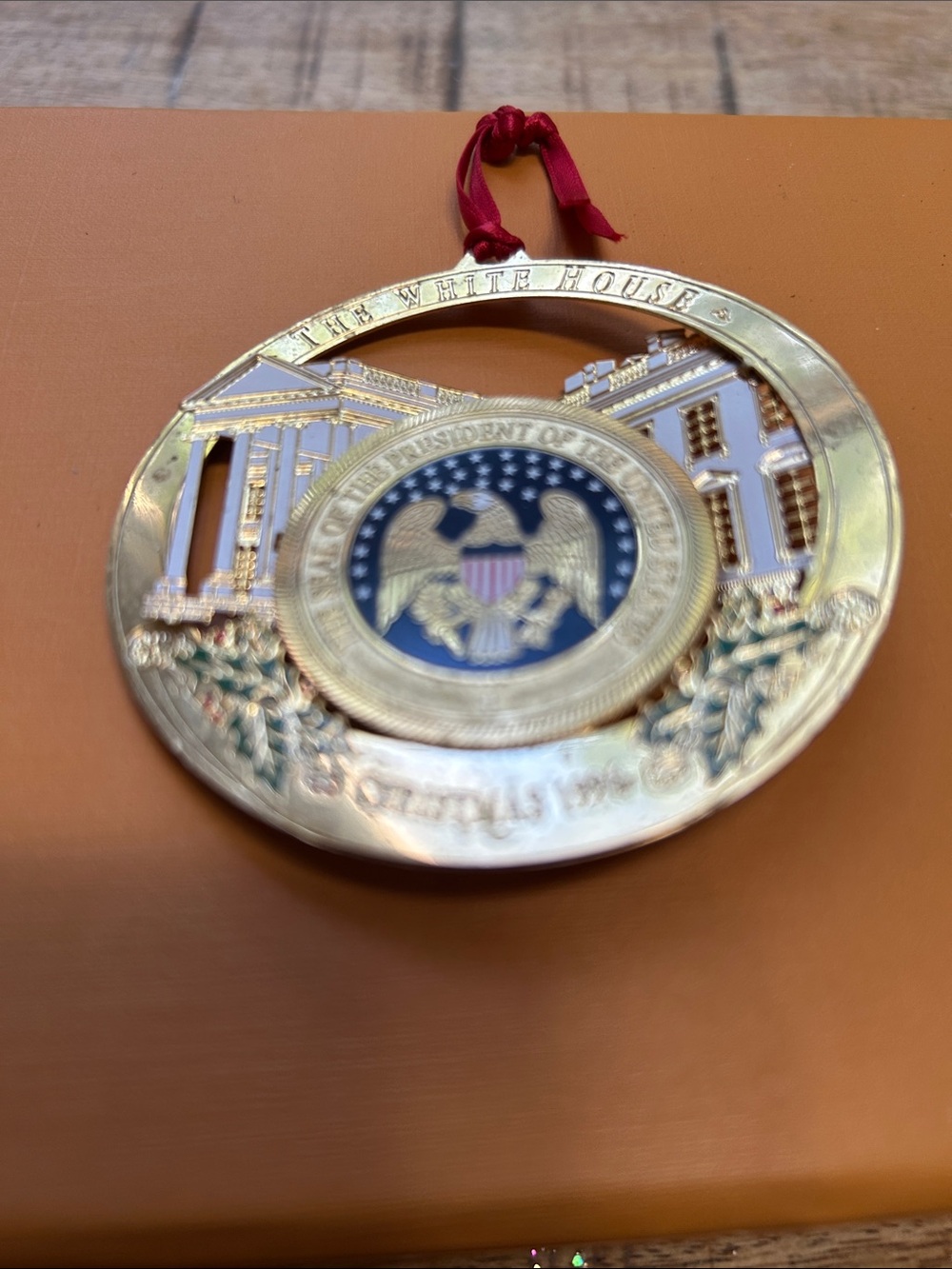 The White House Gold Presidential Seal Holiday Ornament - Red Ribbon 1996
